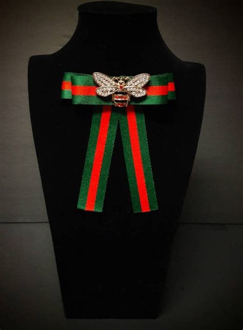 gucci pins and brooches|Gucci bow tie brooch.